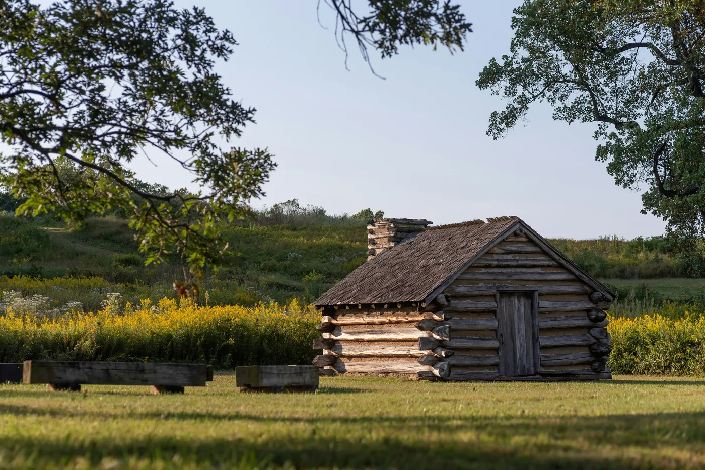 Rustic cabin in a grassy rural setting